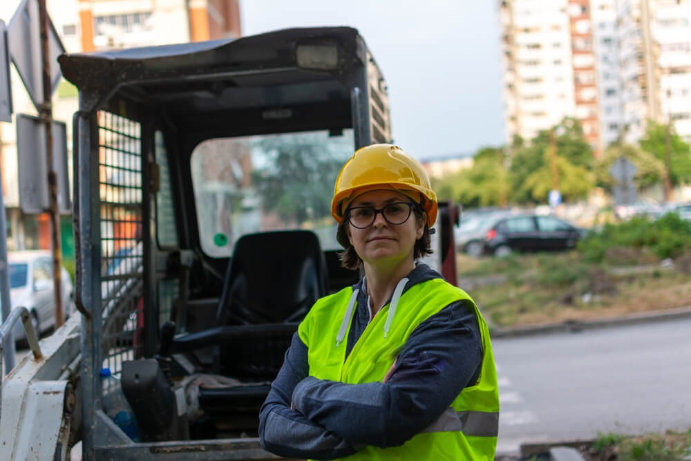 Women with safety wear for heavy equipments